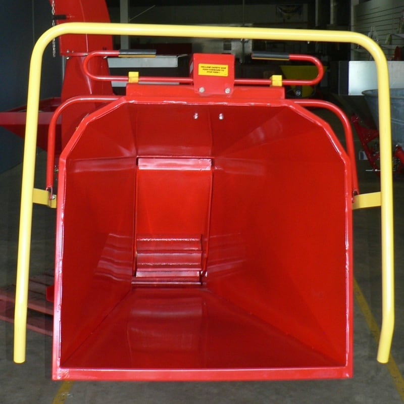 The hydraulic infeed chute showing the safety bar and feed direction lever.